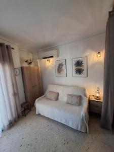 a bedroom with a large white bed and a table at RETIRO V - Los Quesitos in Denia +33 photos