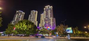 um grupo de edifícios altos em uma cidade à noite em D & B Luxury Apartment 26th floor em Skopje