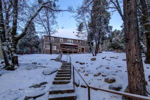 a house in the snow with stairs in front at Historic Mountain Retreat - Near Boreal - 3 Kings in Emigrant Gap