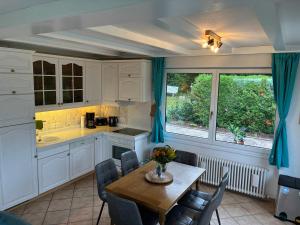 a kitchen with a table and chairs and a window at Haus Tierlieb in Stadtkyll