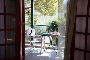 an open door to a balcony with a table and a chair at Beach Villa Pasithea in Neokhórion