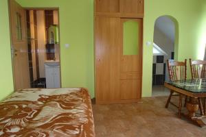 a room with a bed and a table in it at Noclegi Zlota Gorka in Polańczyk