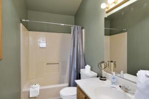 a bathroom with a sink and a toilet and a shower at Moonridge Treehouse - Relaxing Lofty Big Bear Hillside Retreat- Great Deck Views- Central in Big Bear Lake +16 photos
