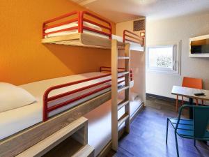 a bunk bed room with two bunk beds and a desk at hotelF1 Paris Saint Denis Stade in Saint-Denis