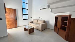 a living room with a chair and a table at Brand New Cow House Aldea Hortus 136 by Kivoya in Naranjo +32 photos