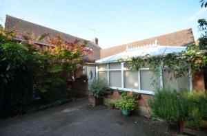 a brick house with plants on the side of it at The Annex - Guest Gardens in Milton Keynes