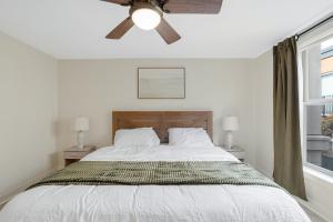 a bedroom with a bed with a ceiling fan at Charming Hillsboro Condo with Pool and Gym in Hillsboro