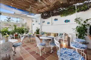 a restaurant with tables and chairs and plants at Casa Mary Hotel in Cartagena de Indias