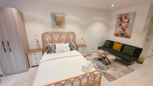 a bedroom with a bed and a couch at The Lennox Suites by Cozy in Accra +126 photos
