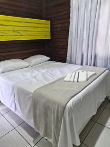 two beds sitting next to each other in a room at Apartamento 3,3km oktoberfest até 2 pessoas com opção de café da manhã in Blumenau