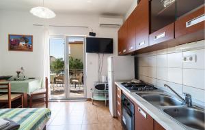 a kitchen with a sink and a stove at 1 Bedroom Lovely Apartment In Omis in Tice