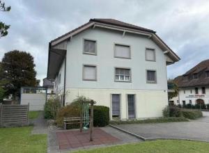 a white house with a bench in front of it at AIRR Wohnung in Flumenthal in Flumenthal