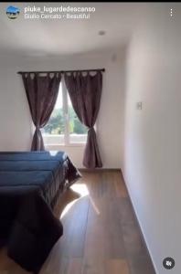 a bedroom with two beds and a window at PIUKE lugar de descanso in Tandil +5 photos