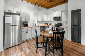 a kitchen with a table and chairs and a refrigerator at Charming & Spacious Hideaway by Downtown Bryan in Bryan