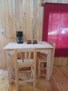 a table with two chairs and a coffee maker on top at Cabaña en el Rancho in San Jose del Pacifico +12 photos