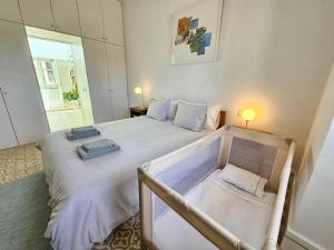 a bedroom with a bed with two towels on it at Eco-Villa Monte Do Barrocalinho in Loulé