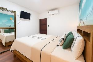 a bedroom with a large bed and a mirror at XIN Bed&Breakfast in San José