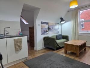 a kitchen and living room with a couch and a table at Self contained Flat & Large Ensuite Rooms RG2 Near Town Centre & Hospital in Reading +91 photos