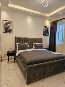 a bedroom with a large bed and a window at Tranquility Inn in Buzzi