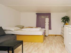 a living room with two beds and a couch at 6 person holiday home in Eskebjerg-By Traum in Eskebjerg