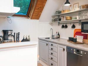 a kitchen with a sink and a counter top at 6 person holiday home in Herning in Herning +18 photos