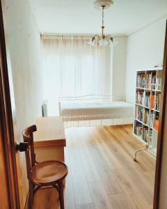 a room with a bed and a table and a chair at La Bohemia de Potes in Potes