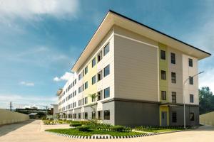a large white building with at Plumera Mactan near Airport in Bankal
