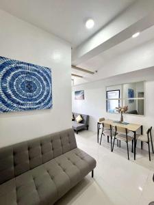 a living room with a couch and a table at The Coastal Cove - One Bedroom in Iloilo City