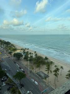 a view of a beach with palm trees and the ocean at Place Beira Mar in Recife