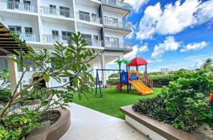 a playground in front of a apartment building at The Coastal Cove - One Bedroom in Iloilo City