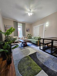 a living room with a couch and a table at King Comfort Retreat in Peterborough
