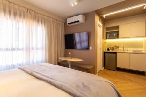 a hotel room with a bed and a kitchen at Luxury Studio for 4 People - Allianz Park in Sao Paulo