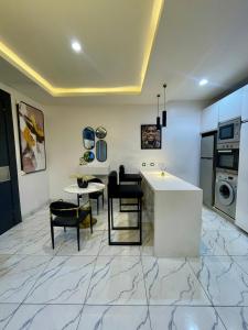 a kitchen and dining room with a table and chairs at Emiola mews apartments in Lekki +4 photos