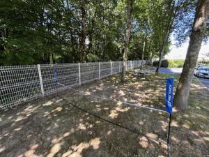 a fence with a sign on it next to a tree at Hôtel Ibis Budget Nantes Nord St Herblain in Saint-Herblain +66 photos