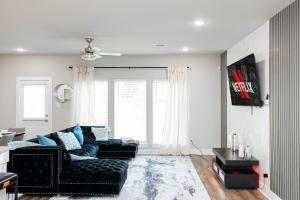 a living room with a couch and a table at Luxury 3BR Getaway Near Downtown - Med Center - NRG - Enjoy Smart TVs - Fast WiFi - Private Backyard in Houston