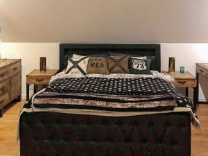 a bedroom with a large bed with pillows on it at 4 star holiday home in Åkersberga in Åkersberga