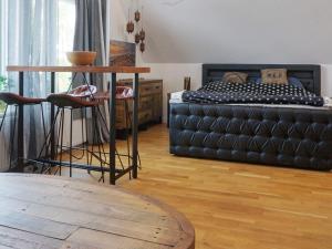 a bedroom with a bed and a table and chairs at 4 star holiday home in Åkersberga in Åkersberga