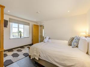a bedroom with a large bed and a window at The Granary - Uk49090 in Crediton +16 photos