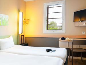 Postel nebo postele na pokoji v ubytování Ibis Budget Manosque Cadarache