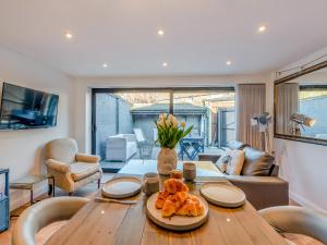 a living room with a table with food on it at Harbour Lodge - Uk49490 in Whitstable +16 photos