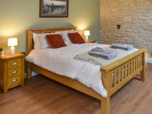 a bedroom with a bed with two pillows and two lamps at The Loft - Uk50284 in Earl Sterndale