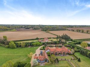 an aerial view of a large house in a field at Wittle Cottage in Quidenham