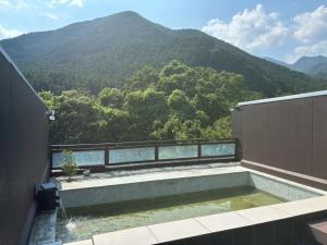 a balcony with a view of a mountain at 大同ガーデンホテル湯の山リゾート in Wada