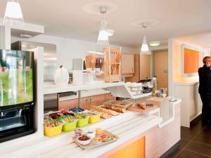 a kitchen with a counter with food on it at ibis budget Amberieu en Bugey/Chateau Gaillard A42 in Château-Gaillard