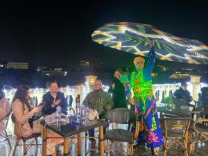 un hombre sosteniendo un paraguas sobre un grupo de personas en ImHoteP Hotel, en El Cairo