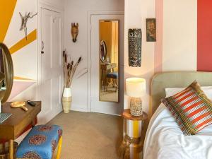 a bedroom with a bed and a table and a mirror at The Artists Retreat in Whitby +9 photos