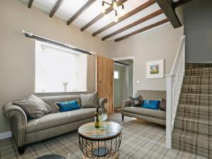 a living room with a couch and a table at Pinfold Cottage in Richmond