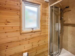 a bathroom with a shower and a window at Thula Lodge in Chichester +3 photos