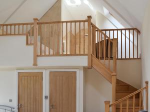 a staircase in a house with wooden doors at The Farm House in Wolsingham