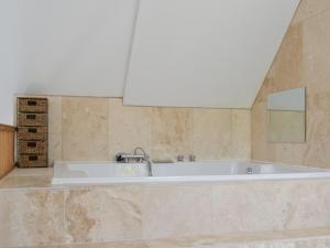 a bath tub in a bathroom with a mirror at The Farm House in Wolsingham +14 photos